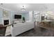 Open-concept living room with fireplace, dark hardwood floors, and lots of natural light at 2106 White Pond Ct, Apex, NC 27523