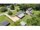 Aerial view of property showcasing the house, detached garages, and spacious lot surrounded by mature trees at 2119 Northcrest Dr, Elon, NC 27244