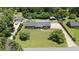 Aerial view of a house with a lush green lawn and a long driveway at 2119 Northcrest Dr, Elon, NC 27244