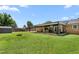 Expansive backyard featuring a covered patio with an outdoor kitchen and a fire pit at 2119 Northcrest Dr, Elon, NC 27244