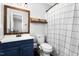 Bathroom boasts updated vanity and framed mirror with tiled shower and toilet at 2119 Northcrest Dr, Elon, NC 27244
