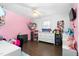 Bright bedroom with hardwood floors, a ceiling fan, playful decor, and plenty of storage for toys at 2119 Northcrest Dr, Elon, NC 27244