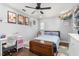 Bright bedroom featuring wood floors, a ceiling fan, and a charming workspace at 2119 Northcrest Dr, Elon, NC 27244