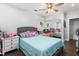 Comfortable bedroom showcasing wood floors, ceiling fan, and mirrored closet doors at 2119 Northcrest Dr, Elon, NC 27244