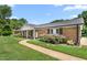 Inviting brick home featuring a lovely walkway and manicured landscaping at 2119 Northcrest Dr, Elon, NC 27244