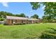 Beautifully landscaped front yard showcasing a charming brick home with a well-manicured lawn at 2119 Northcrest Dr, Elon, NC 27244