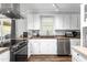 Updated kitchen features stainless appliances, ample cabinet space, and sleek countertops at 2119 Northcrest Dr, Elon, NC 27244