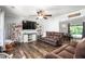 Cozy living room featuring hardwood floors, a ceiling fan, and comfortable seating at 2119 Northcrest Dr, Elon, NC 27244