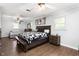 Spacious main bedroom boasts ceiling fan, wood floors, and comfortable seating area at 2119 Northcrest Dr, Elon, NC 27244