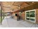 Inviting outdoor patio with bar, ceiling fans, and brickwork, perfect for entertaining and relaxation at 2119 Northcrest Dr, Elon, NC 27244