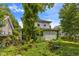 View of overgrown backyard, featuring foliage with a white siding house at 218 Villa St, Rocky Mount, NC 27804