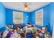 Bright blue bedroom with hardwood floors, ceiling fan, and ample natural light, awaiting personalization at 218 Villa St, Rocky Mount, NC 27804