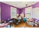 Bedroom with hardwood floors, purple walls, and two windows providing natural light, a canvas for customization at 218 Villa St, Rocky Mount, NC 27804