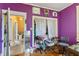 Cozy bedroom with hardwood floors, purple walls, and unique decor, located off another room at 218 Villa St, Rocky Mount, NC 27804