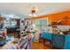 Eclectic bedroom with orange walls, ceiling fan, open shelves, and attached kitchen, providing a unique living space at 218 Villa St, Rocky Mount, NC 27804