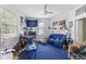 Bedroom features a ceiling fan, large windows and a blue carpet at 218 Villa St, Rocky Mount, NC 27804