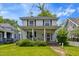 Charming two-story home featuring a welcoming front porch with classic columns at 218 Villa St, Rocky Mount, NC 27804