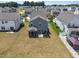Aerial shot of the home with a large backyard featuring a screened porch and hammock at 22 Combine Trl, Benson, NC 27504