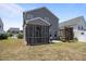 View of the backyard featuring a screened porch, seating area, and hammock at 22 Combine Trl, Benson, NC 27504