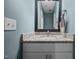 Cozy bathroom featuring a white vanity with a granite countertop and a framed mirror with a towel at 22 Combine Trl, Benson, NC 27504
