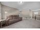 Large bonus room with plush carpeting and a comfortable brown sofa at 22 Combine Trl, Benson, NC 27504