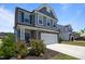 Two story home with stone accents, well-manicured lawn, and driveway at 22 Combine Trl, Benson, NC 27504
