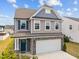 Charming two-story home featuring a two-car garage and manicured front yard at 22 Combine Trl, Benson, NC 27504