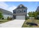 Beautiful two-story home with a white garage door and manicured front yard at 22 Combine Trl, Benson, NC 27504