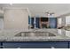 Kitchen island with stainless steel sink, granite countertops and a view of the living room at 22 Combine Trl, Benson, NC 27504