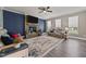 Comfortable living room with a stone fireplace, large rug, ceiling fan, and plenty of natural light at 22 Combine Trl, Benson, NC 27504
