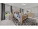 Beautifully staged main bedroom with elegant furniture, neutral colors, and a view to the neighborhood at 22 Combine Trl, Benson, NC 27504
