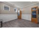 Versatile room with white wainscoting, gray wood floors, and a cabinet providing storage space at 22 Combine Trl, Benson, NC 27504