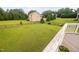 Expansive backyard features lush lawn, black metal fencing, and mature trees, perfect for outdoor activities at 265 Beckwith Ave, Clayton, NC 27527