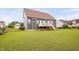 Backyard with a lawn, gray siding, and a black metal fence at 265 Beckwith Ave, Clayton, NC 27527
