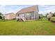 Fenced backyard with lush green lawn and patio with white railings at 265 Beckwith Ave, Clayton, NC 27527