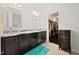 Well-lit bathroom featuring a dual sink vanity with dark wood cabinets and access to a walk-in closet at 265 Beckwith Ave, Clayton, NC 27527