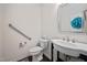 Bright bathroom with a sleek pedestal sink and modern fixtures offers accessibility at 265 Beckwith Ave, Clayton, NC 27527