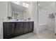 Modern bathroom with double sinks and a spacious vanity with dark cabinets at 265 Beckwith Ave, Clayton, NC 27527