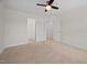 Neutral bedroom features carpet, ceiling fan, and two walk-in closets at 265 Beckwith Ave, Clayton, NC 27527