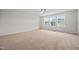 A spacious bedroom is brightened by natural light from three large windows at 265 Beckwith Ave, Clayton, NC 27527