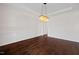 Dining room features dark hardwood floors, white trim, and an elegant light fixture at 265 Beckwith Ave, Clayton, NC 27527