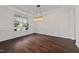 Formal dining room with rich hardwood floors and detailed wainscoting under a decorative light fixture at 265 Beckwith Ave, Clayton, NC 27527