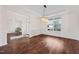Bright dining room featuring dark hardwood floors, neutral walls, large window, and elegant chandelier at 265 Beckwith Ave, Clayton, NC 27527