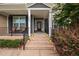 Close-up of a decorated front porch with floral arrangements and a welcoming entrance at 265 Beckwith Ave, Clayton, NC 27527