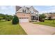 Attractive two-story home with brick accents, two-car garage, and inviting front lawn at 265 Beckwith Ave, Clayton, NC 27527