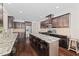 An open concept kitchen with granite countertops, stainless steel appliances, dark wood cabinets and flooring at 265 Beckwith Ave, Clayton, NC 27527
