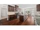 Spacious kitchen with granite countertops, stainless steel appliances, a kitchen island, and dark wood cabinets at 265 Beckwith Ave, Clayton, NC 27527