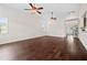 Expansive living room features dark hardwood floors, neutral walls, and large windows at 265 Beckwith Ave, Clayton, NC 27527