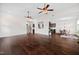 Open-concept living room with dark wood floors and views into kitchen and dining areas at 265 Beckwith Ave, Clayton, NC 27527