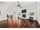 Spacious living room boasts dark wood floors, fireplace, ceiling fan, and neutral decor at 265 Beckwith Ave, Clayton, NC 27527